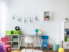 Rainbow_tween_study_area_white_walls_pink_blue_chair_green_presents_plants_fluffy_rug_ottoman